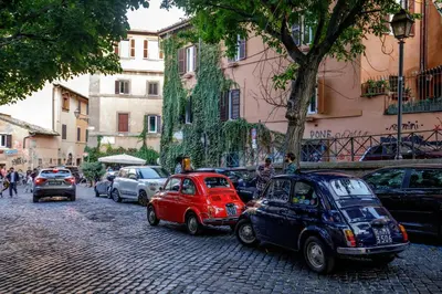 a group of cars parked on the side of a street at Tiberim Lux Penthouse City View in Rome