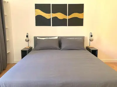 a bedroom with a large bed with two lamps at Domus Adriana Ada - adiacente metro A in Rome