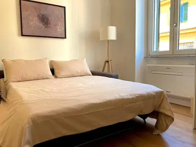 a bedroom with a large bed with a window at Domus Adriana Ada - adiacente metro A in Rome