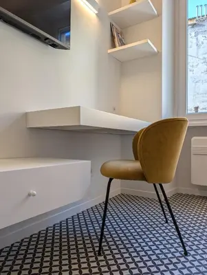 a yellow chair in a room with a kitchen at Monti Elite House in Rome