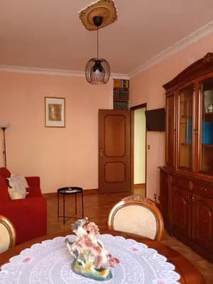 a living room with a table and a red couch at Chez Michel in Rome