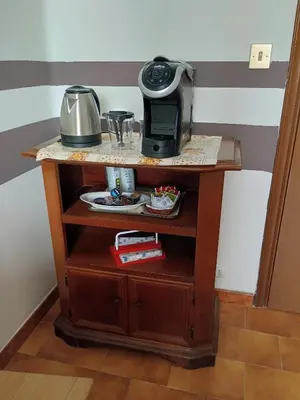 a table with a coffee maker on top of it at Chez Michel in Rome
