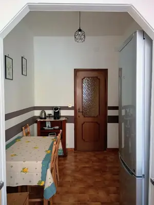 a room with a bed and a wooden door at Chez Michel in Rome