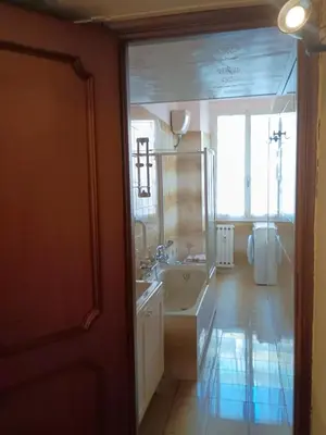 a bathroom with a sink and a large window at Chez Michel in Rome