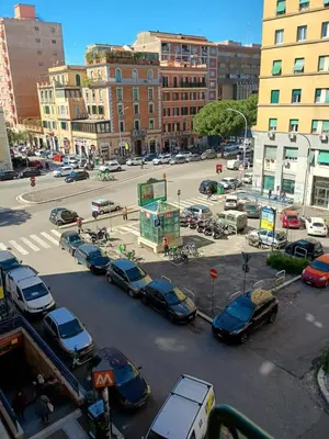 a parking lot with cars parked in a city at Chez Michel in Rome