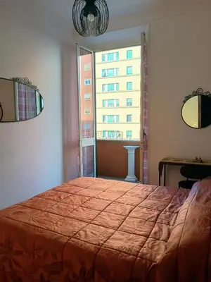 a bedroom with a large bed and a window at Chez Michel in Rome