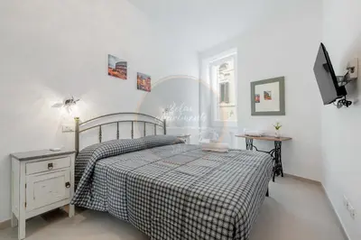a bedroom with a bed with a checkered blanket at Imperial Luxury in Rome