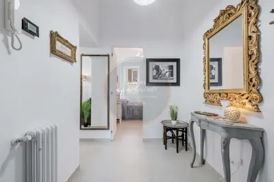 a hallway with a mirror and a table at Imperial Luxury in Rome