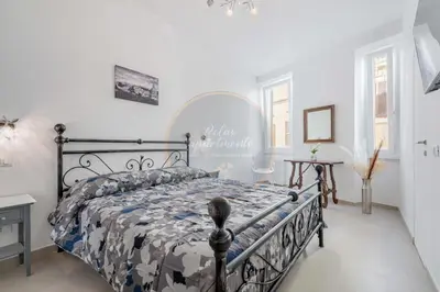 a bedroom with a bed with a comforter at Imperial Luxury in Rome