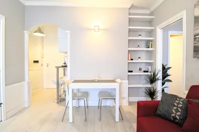 a living room with a white table and chairs at Casa di Lola Metro Conca d' Oro in Rome