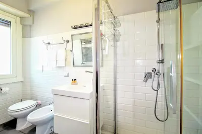 a bathroom with a shower and a toilet and a sink at Casa di Lola Metro Conca d' Oro in Rome