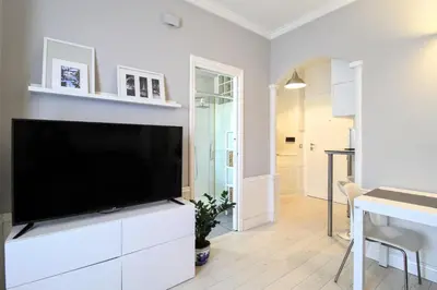 a living room with a large flat screen tv at Casa di Lola Metro Conca d' Oro in Rome