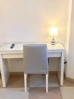 a white desk with a chair and a lamp at The Prince Suite in Rome