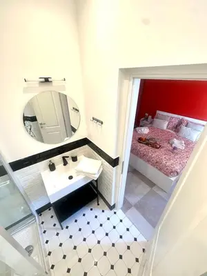 a bathroom with a sink and a mirror at The Prince Suite in Rome