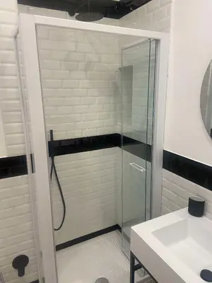 a glass shower in a bathroom with a sink at The Prince Suite in Rome