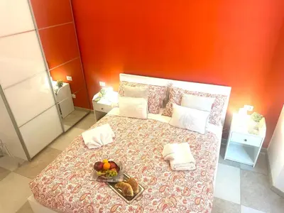 a bedroom with a bed with a tray of fruit on it at The Prince Suite in Rome