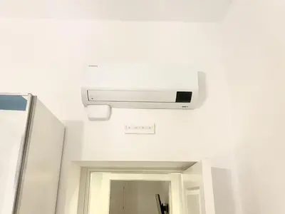 a light on the ceiling of a bathroom with a mirror at The Prince Suite in Rome
