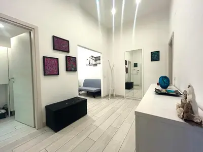 a living room with a counter and a room with a couch at Statilia Urban Retreat in Rome