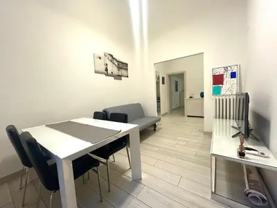 a living room with a white table and chairs at Statilia Urban Retreat in Rome