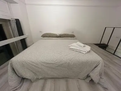 a bed with two white towels sitting on top of it at Statilia Urban Retreat in Rome