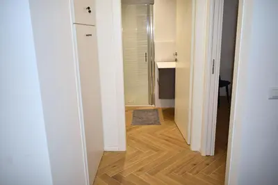 a hallway with a door leading into a room with a wooden floor at Dimora Artis by Gialel in Rome