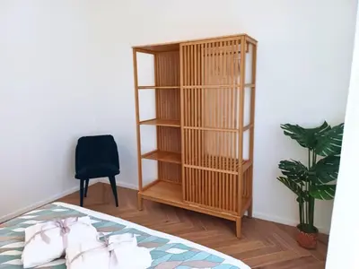 a book shelf in a room with a bed and a chair at Dimora Artis by Gialel in Rome