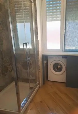 a bathroom with a shower and a washing machine at Elegance Penthouse 959 in Rome