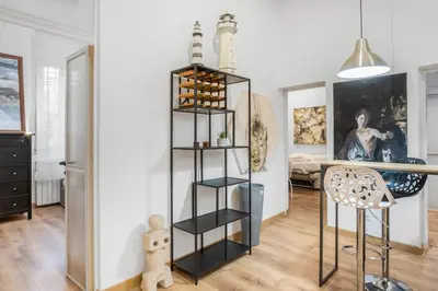 a living room with a black book shelf at L'Arte Dei Sogni Apartment With Terrace- Trastevere District in Rome