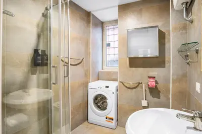 a bathroom with a washing machine and a sink at L'Arte Dei Sogni Apartment With Terrace- Trastevere District in Rome