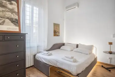 a small bedroom with a bed with towels on it at L'Arte Dei Sogni Apartment With Terrace- Trastevere District in Rome