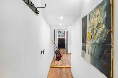 a hallway with a large painting on the wall at L'Arte Dei Sogni Apartment With Terrace- Trastevere District in Rome