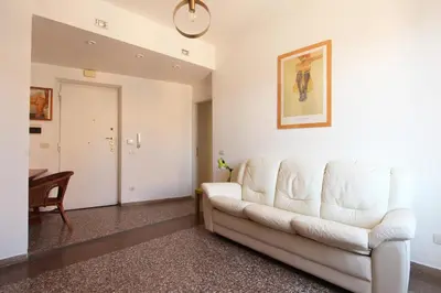 a living room with a white couch and a table at Julia Apartment in Rome