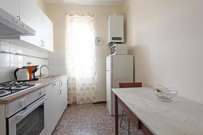 a kitchen with a white refrigerator and a counter top at Julia Apartment in Rome