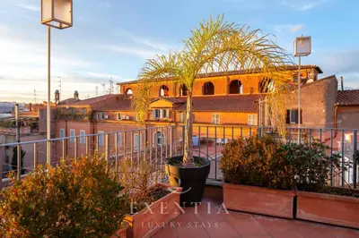 a patio with couches and chairs on a building at Exentia Stays - Luxury Penthouse Spanish Steps in Rome