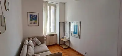 a living room with a couch and a mirror at CA' MATI Alloggio Turistico Vaticano in Rome