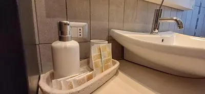 a bathroom with a soap dispenser and a sink at CA' MATI Alloggio Turistico Vaticano in Rome