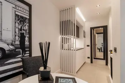 a living room with a hallway with a vase at JOIVY Borghese Luxury Suite in Rome