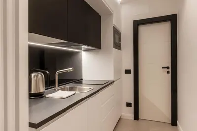 a kitchen with a sink and a counter at JOIVY Borghese Luxury Suite in Rome