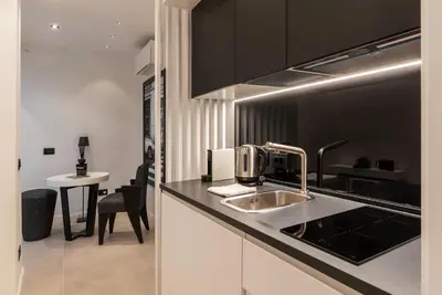 a kitchen with a sink and a counter top at JOIVY Borghese Luxury Suite in Rome