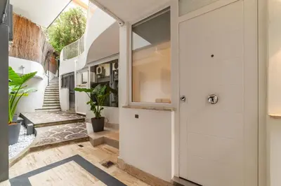 a hallway with white cabinets and a glass door at JOIVY Borghese Luxury Suite in Rome