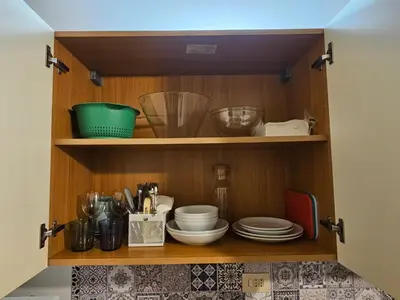 a cupboard with plates and other kitchen utensils at Raggio di Sole in Rome