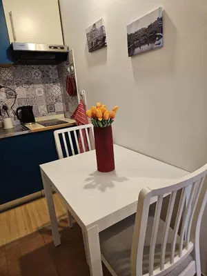 a white table with a vase of oranges on it at Raggio di Sole in Rome