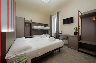 a hotel room with a large bed and a desk at Termini Comfort Rooms and Jacuzzi Suite by Flatinrome in Rome