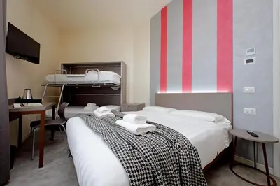 a bedroom with two bunk beds and a desk at Termini Comfort Rooms and Jacuzzi Suite by Flatinrome in Rome
