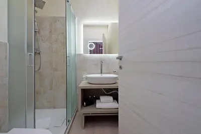 a bathroom with a sink and a shower at Termini Comfort Rooms and Jacuzzi Suite by Flatinrome in Rome