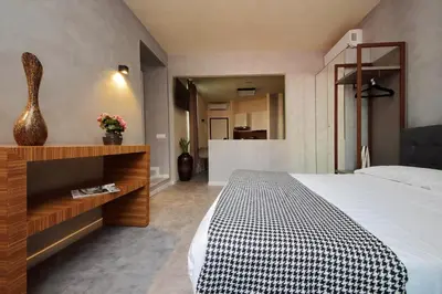 a bedroom with a bed with a black and white checkered blanket at Termini Comfort Rooms and Jacuzzi Suite by Flatinrome in Rome