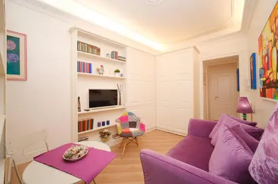 a living room with a purple couch and a table at Ad un passo da San Pietro in Rome