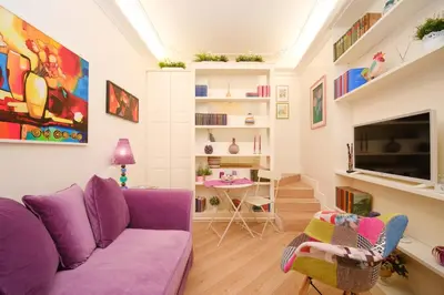 a living room with a purple couch and a table at Ad un passo da San Pietro in Rome