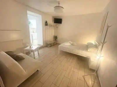 a small room with a bed and a table at Vicolo 17 in Rome