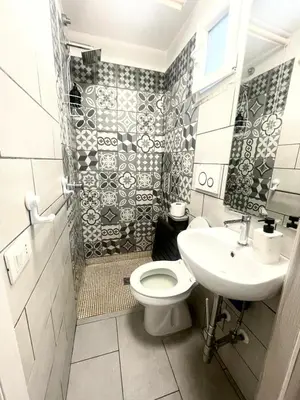 a kitchen with white cabinets and a sink and a dishwasher at Vicolo 17 in Rome